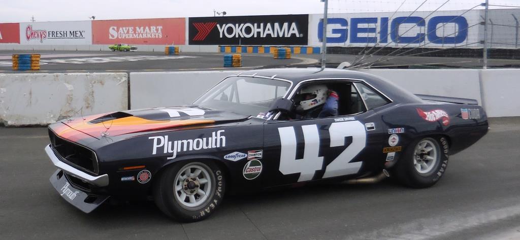 Name:  1970 Plymouth Cuda # 42 being driven back to the pits by Bill Ockerlund.JPG
Views: 507
Size:  130.6 KB